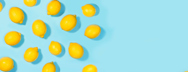 Creative layout made of lemon on green mint color background.