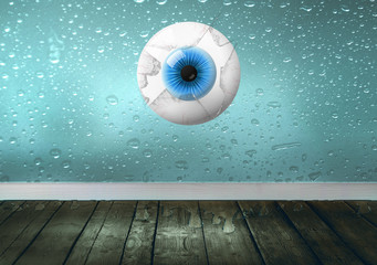 Big blue eye looking through broken glass