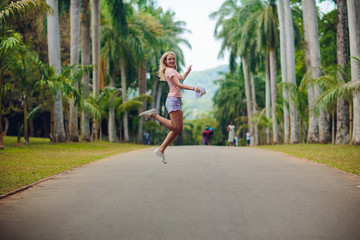 girl walks among the palm trees. girl resting on the lawn. bride on honeymoon. hotel territory....