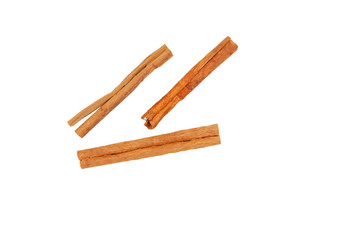 Three pieces of cinnamon lie on a white background, close-up.