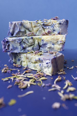 Hand made lavender soaps on the blue background. Copy space. Place for text and design. Natural cosmetic. Home business. Voluntary Isolation