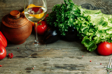 Ripe fresh vegetables on a wooden table. Background of vegetables with an empty space in the middle.