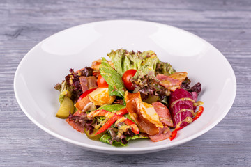 Salad with bacon, pickles, cherry tomatoes, sweet pepper and mustard sauce