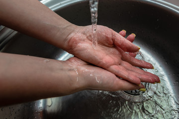 Woman's hands in water splash. Wash the hands