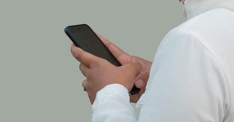 side view woman texting on phone, wearing white dress