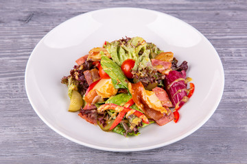 Salad with bacon, pickles, cherry tomatoes, sweet pepper and mustard sauce