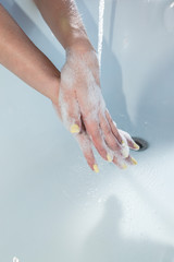 Fototapeta premium Coronavirus pandemic prevention wash hands with soap warm water