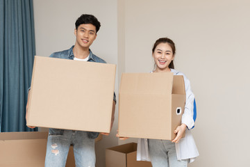 A young asian couple is moving to a new home