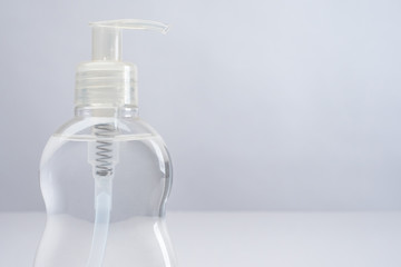 Bottle of disinfectant close-up. Sanitizer on a light background. Liquid for eliminating viruses and bacteria. Place for the label. The fight against the disease during the quarantine.