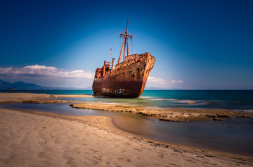 Rusty and abandoned shipwreck stands on a coastline near Gythio in Lakonia. Peloponnese Greece