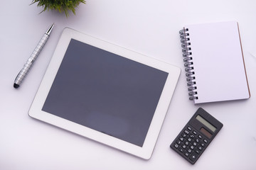 top view of digital tablet and calculator on white backgorund 