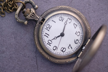Close up of old clock on table, deadline concept.