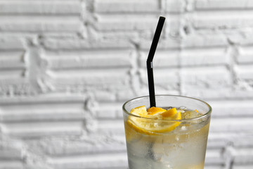 Iced lemon soda glass on wooden table.