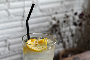Iced lemon soda glass on wooden table.