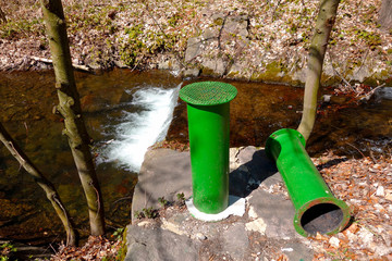 Fototapeta premium Green steel ashtray for cigarettes in nature