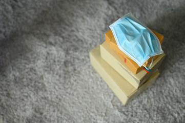 Blue medical mask attached to the package for delivery in selective focus, Concept safe delivery, protection virus, heal care, aid