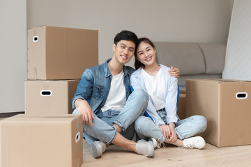 A young asian couple is moving to a new home