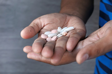 close up of white pills on palm of hand 