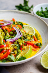 Thai green curry with broccoli, pepper, green beans and coconut milk in a bowl.