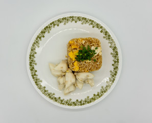 Fried rice with egg along with premium lump crab meat and topped with chopped spring onion. Favorite Thai seafood dish isolated on white