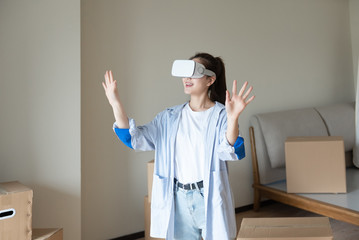 A young asian woman is using VR glasses