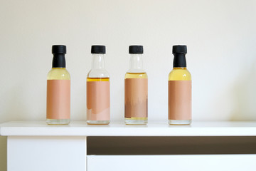 Small mini bottles of flavoured liquid coffee syrup against a white background