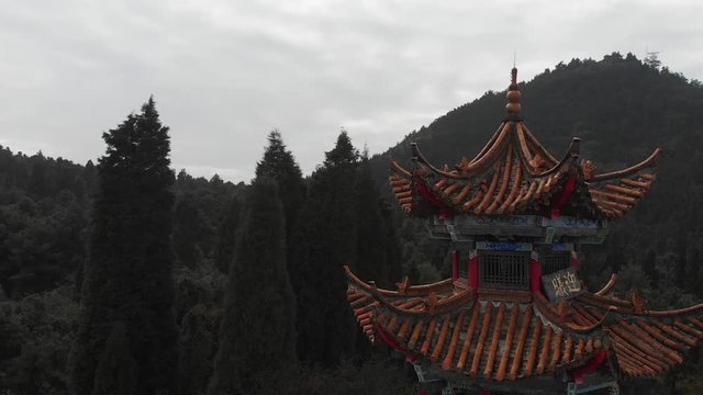 Aerial ascending above a Chinese pavilion at Xishan Forest Park (Western Hills), near Kunming