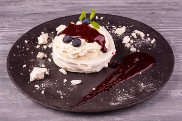 Dessert Pavlova with gentle cream, whipped cream, served with berries and jam