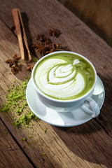 Delicious hot green tea with soft milk foam, Ready to decorate beautifully with green tea, cinnamon and cinnamon powder.
