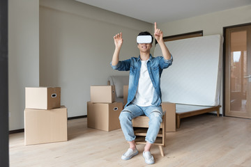 A young asian man is using VR glasses