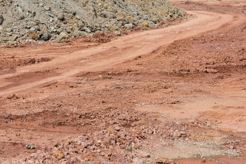 Red dirt road and gravel closeup © bqmeng