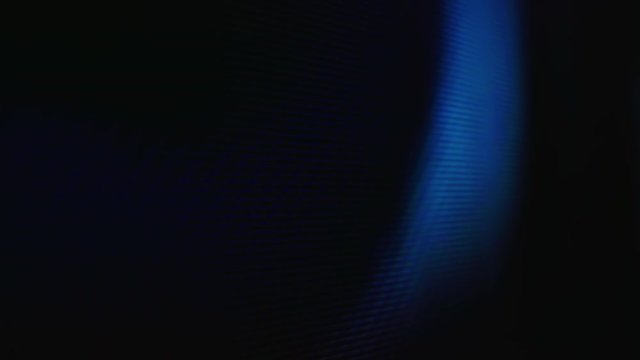 Macro view: bright colorful pixels on LCD red screen of modern TV with playing movie in light room extreme close view