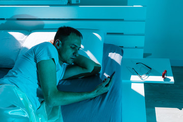 Coronavirus Quarantine Lifestyle. Man Sleeping Lying In Bed At Home During Pandemic Self-Isolation....