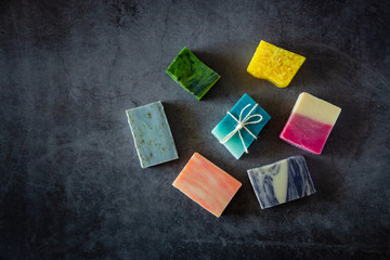 Flat lay of natural handmade soaps. Top view. Dark background. Copyspace