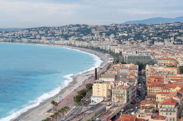 Fototapeta premium Luxury resort of French riviera. Beautiful panorama city of Nice in France. Sunny, summer day. Mediterranean sea, public beach, famous quay, palms and houses of Nice.