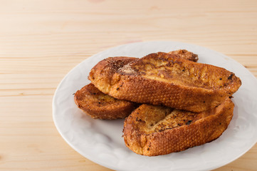 Plate withTorrijas Spanish french toast typical spanish of holy week, isolated on wooden background