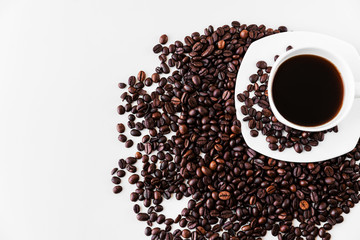 White cup with coffee and saucer, with scattered coffee beans on a white background. Great idea for a cafe, restaurant or cafeteria menu or as a sign.