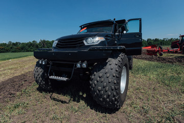 Fototapeta na wymiar black all-terrain vehicle jeep in the field during the test