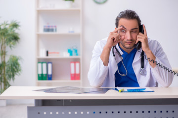 Young male doctor being tired after night shift