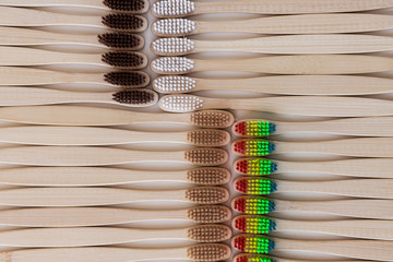 Group of eco bamboo toothbrushes, on white background. Different color. Top view, pattern. Natural...