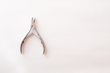 manicure tongs on a white background. nail clippers. Top view. Mock up. Flat lay composition.