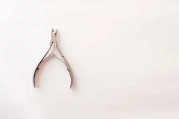 manicure tongs on a white background. nail clippers. Top view. Mock up. Flat lay composition.