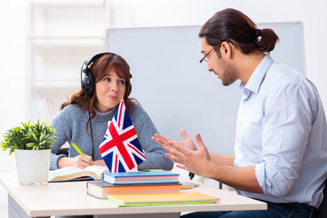 Young female student and male english teacher in the classroom