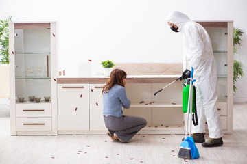 Young male contractor and female client during pest control