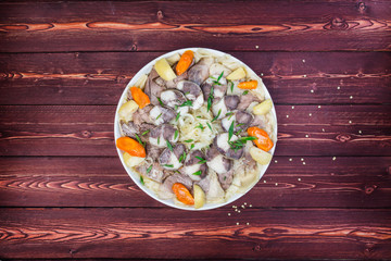 Beshbarmak dish. Noodles with lamb and onion close-up on a plate on the table. Horizontal top view