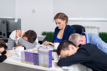 Meeting deadlines concept - a team of exhausted architects working overtime to meet the deadlines