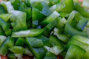 Juicy bell pepper. Raw green pepper sliced small pieces. Health vegetarian food. Macro. Shallow depth of field.