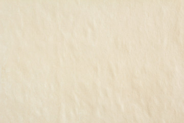 Old crumpled beige brown sheet of paper with rough surface texture background. Blank vintage paper with copy space for text.