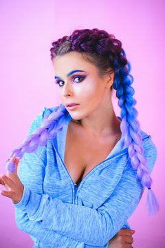 Funny girl with two braids. Girl with long braids. Fashion trend, Fashionable cutie. Hairdresser salon. Hairstyles style.