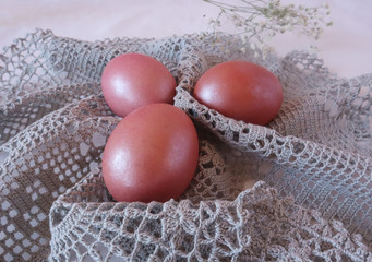 Pink eggs on a gray openwork napkin